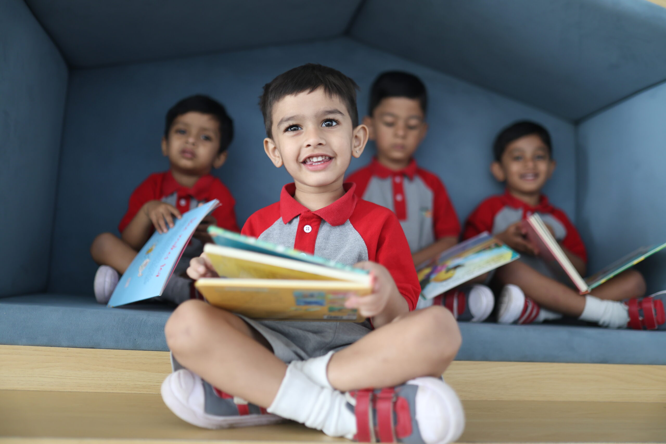 Children reading together at Cambridge Juniors KR Puram